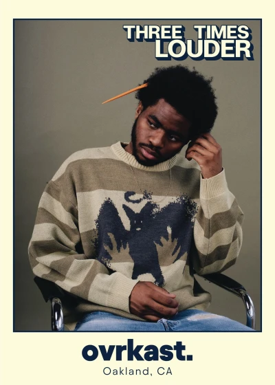 A person in a striped sweater with a graphic design sits in a chair, leaning forward with a contemplative expression and a pencil behind their ear. The image has a vintage style with "THREE TIMES LOUDER" text and "ovrkast. Oakland, CA" at the bottom.